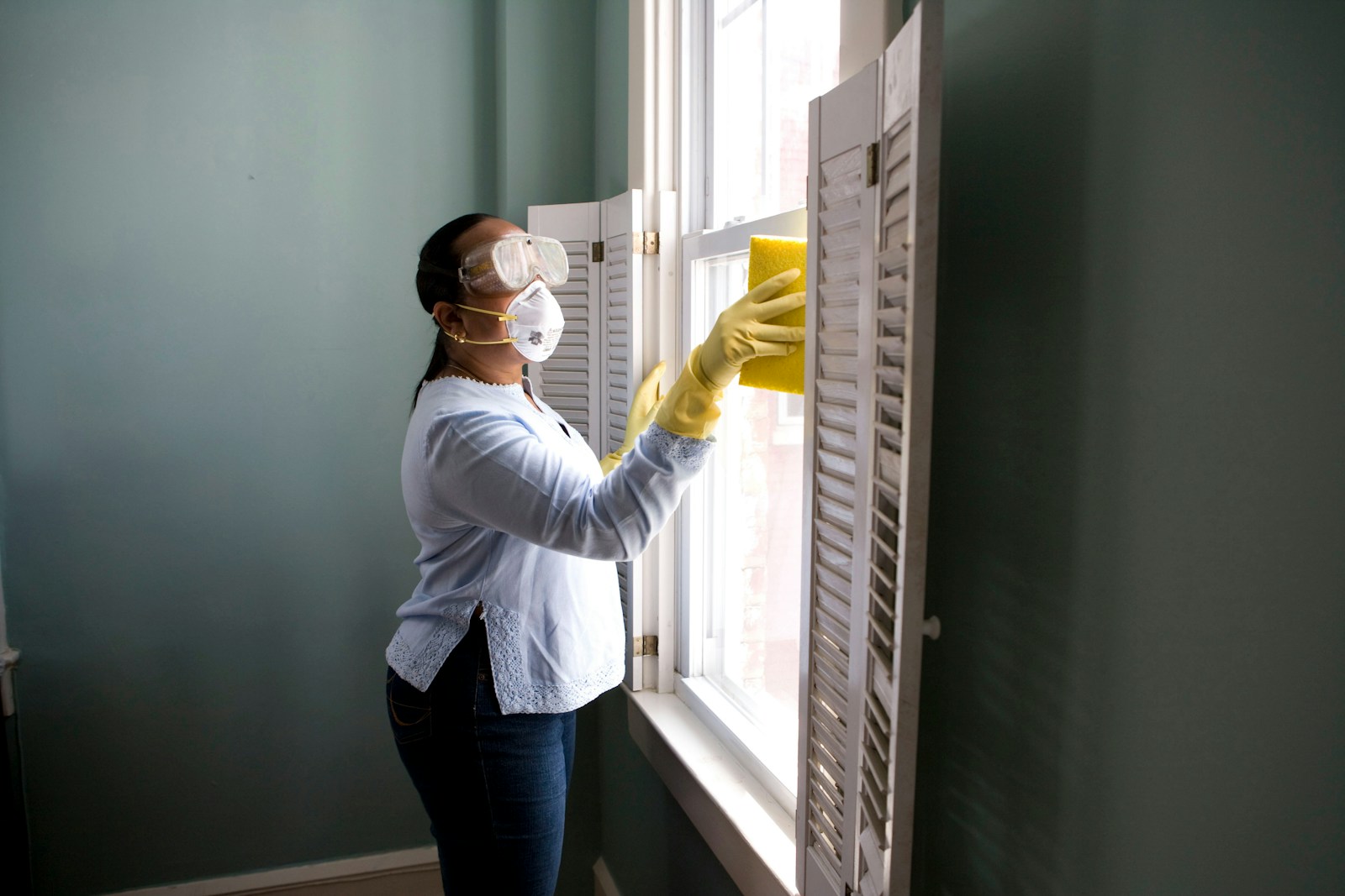 Professional cleaner giving detailed attention to a bright home