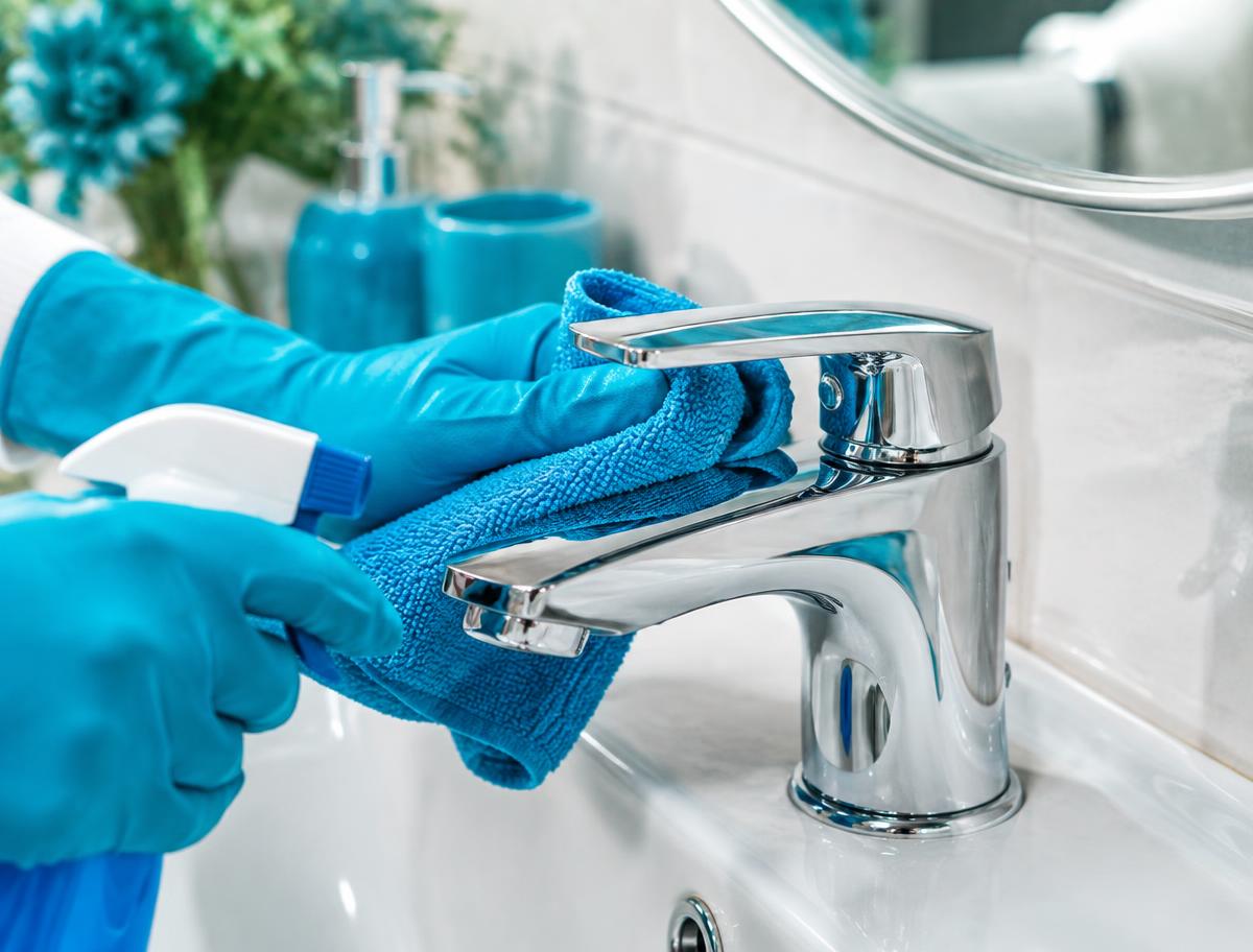 A bathroom tap being polished